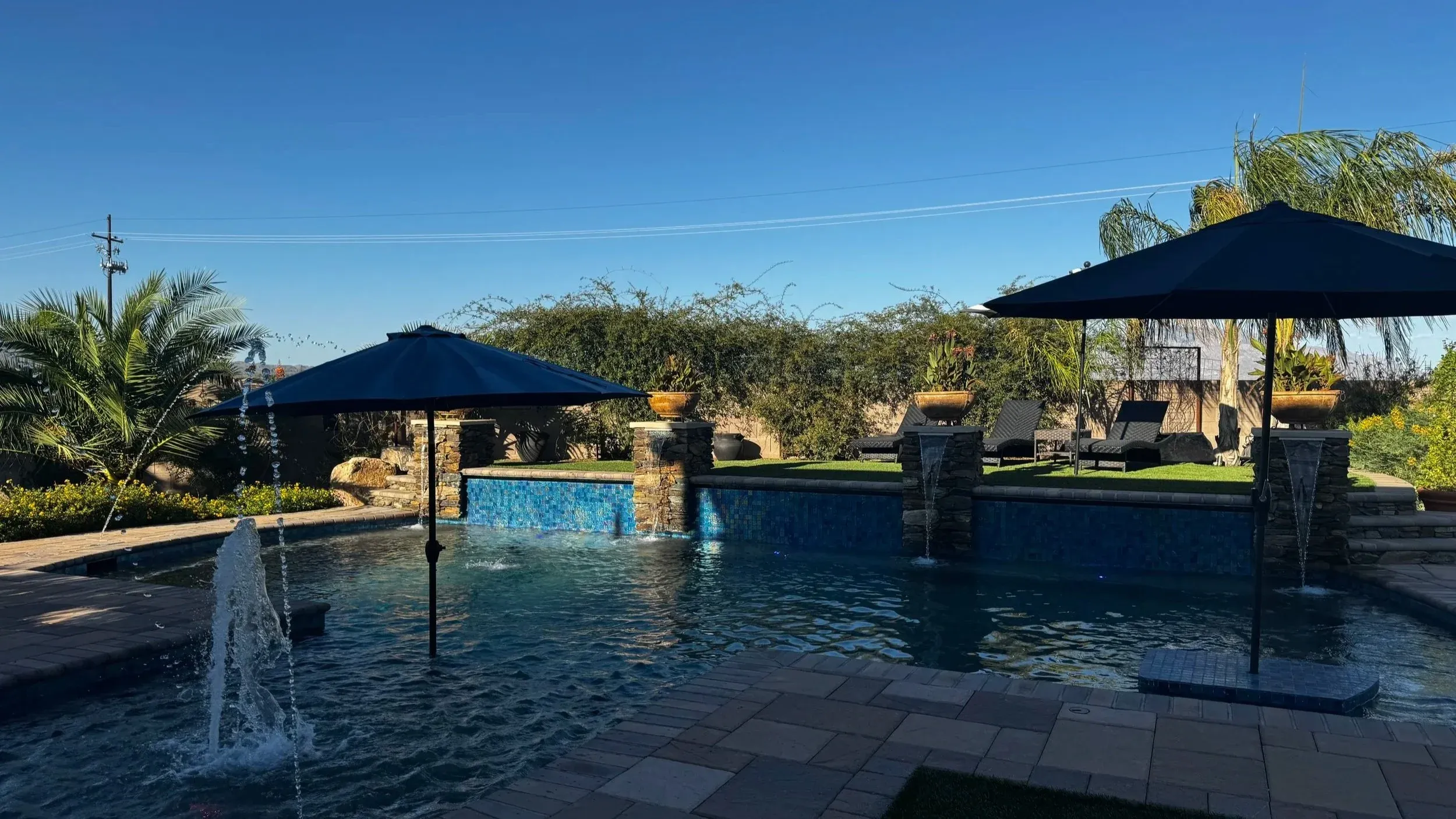 Remodeled Tucson pool with new tile, stone columns and deck jets